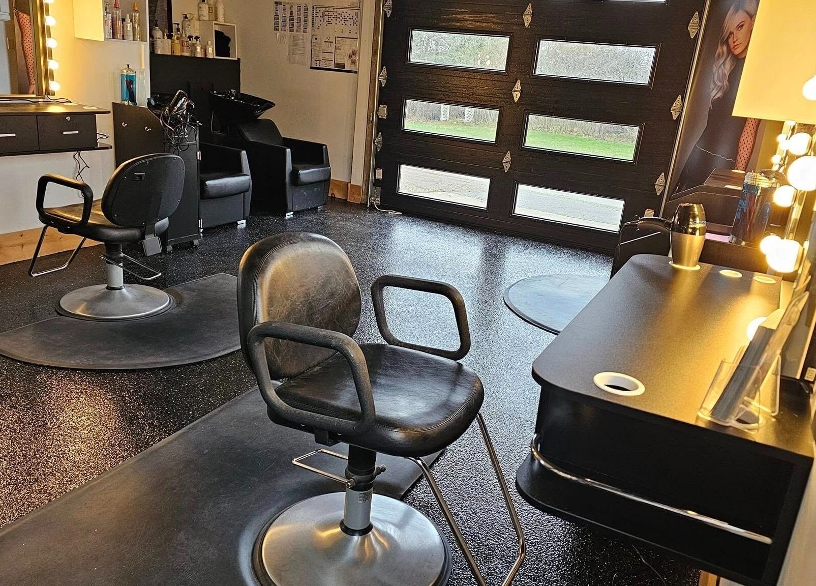 Elegant salon space at Abalone Retreat, Stewiacke, Nova Scotia, CA with modern chairs and illuminated mirrors.