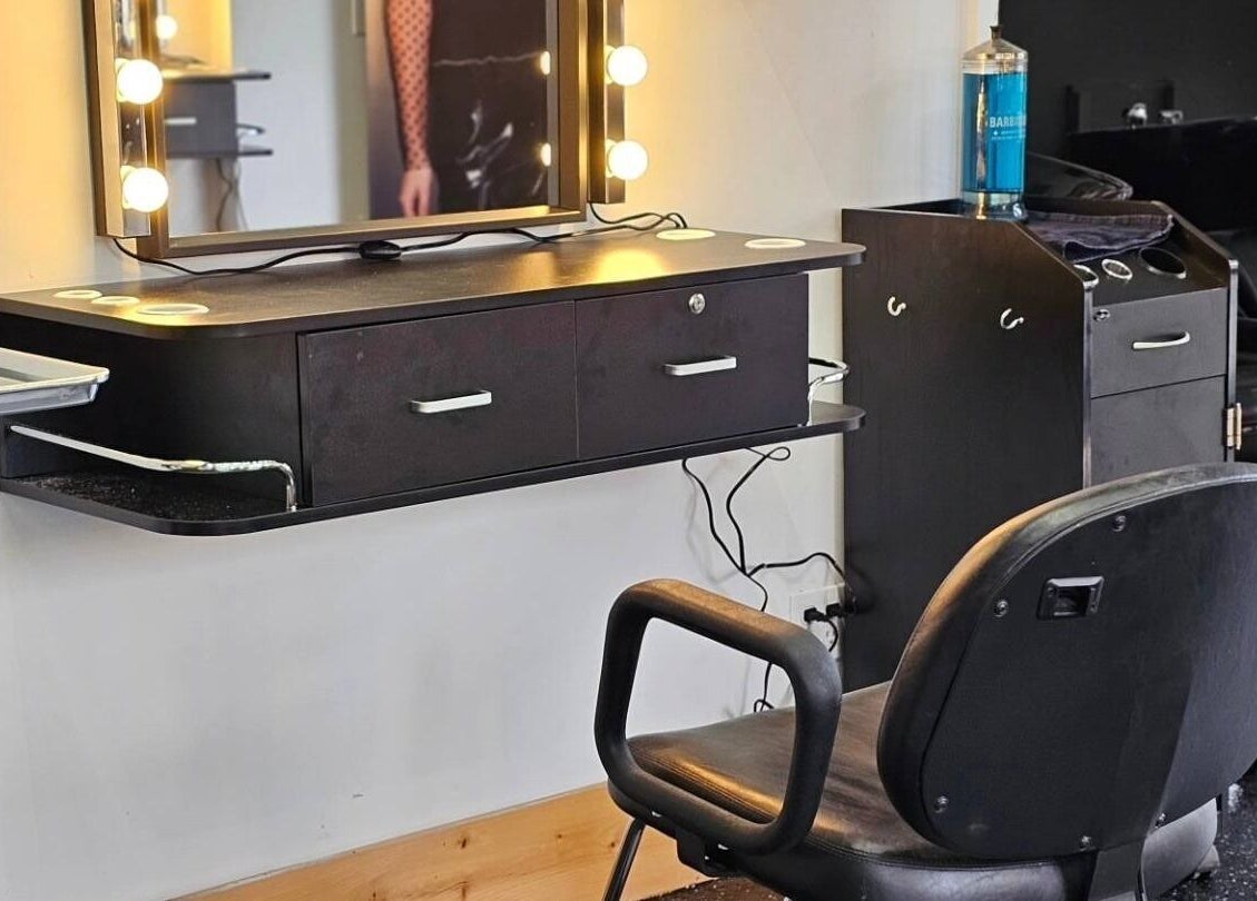 Elegant salon station at Abalone Retreat, Stewiacke, Nova Scotia, CA, featuring a modern styling chair and mirror.
