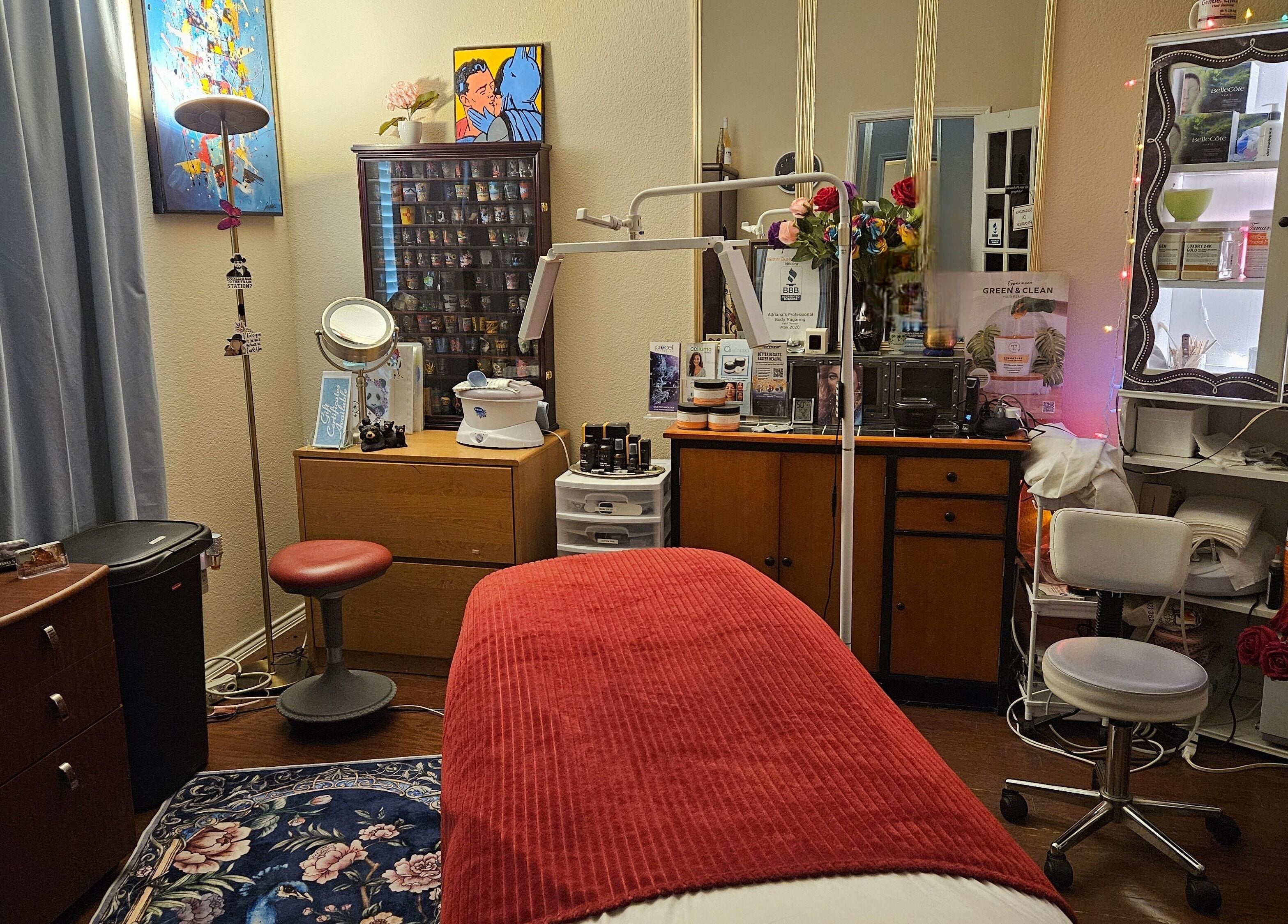Cozy wellness room at Adriana's Professional Body Sugaring, Keller, Texas. Inviting environment with red accent.