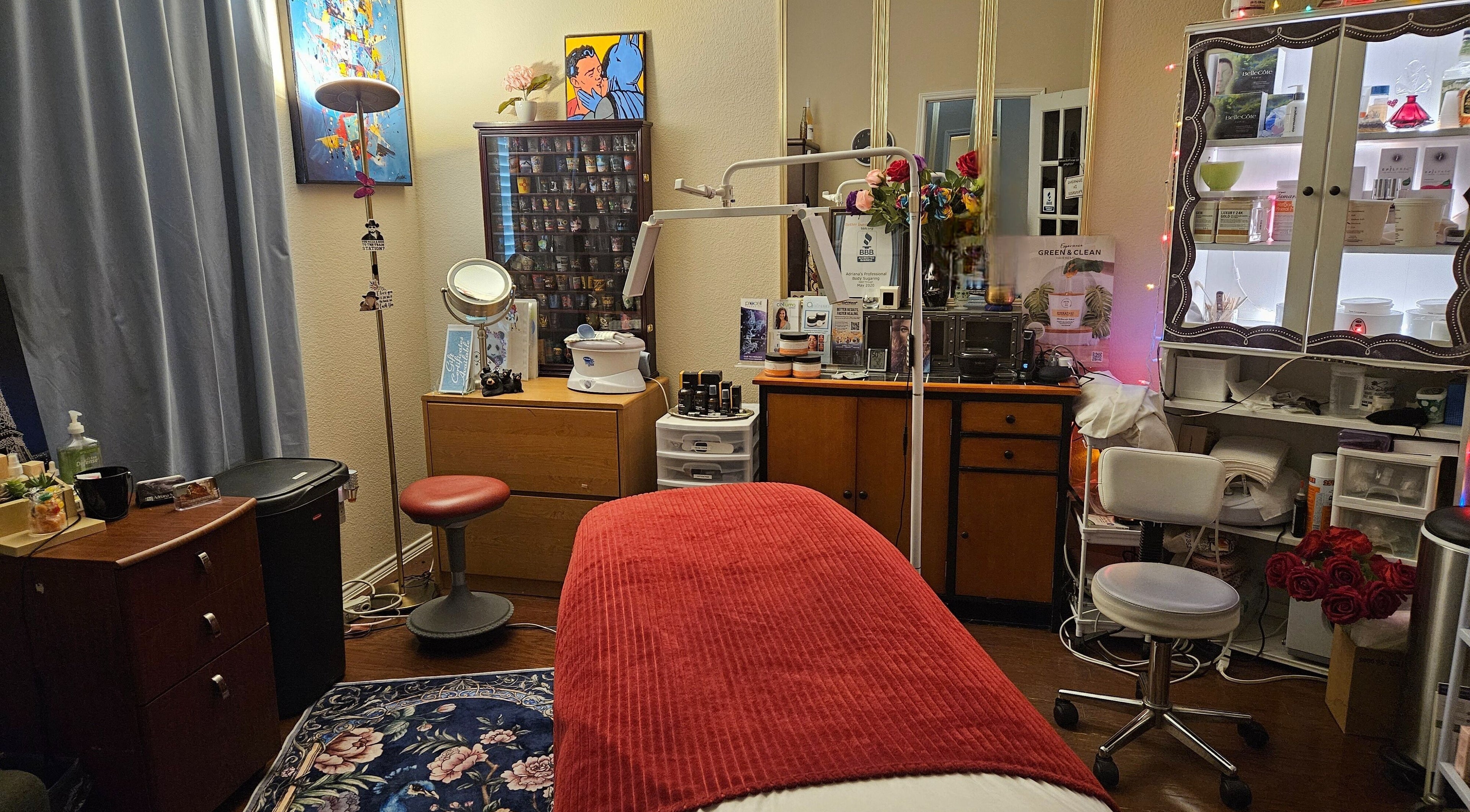 Cozy wellness room at Adriana's Professional Body Sugaring, Keller, Texas. Inviting environment with red accent.