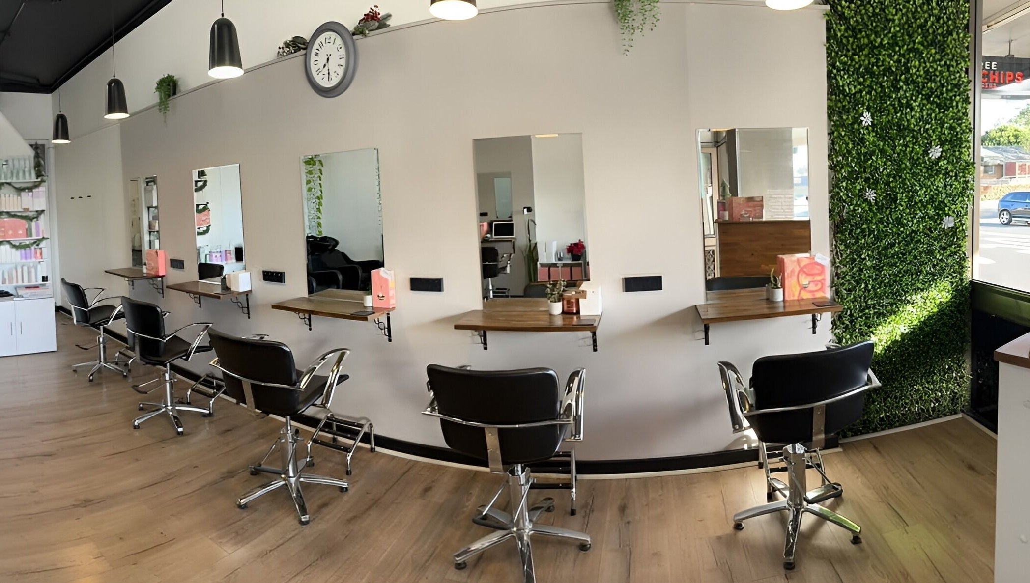 Modern salon interior at Envious Hair And Beauty, Figtree, New South Wales, AU with chic styling chairs and mirrors.