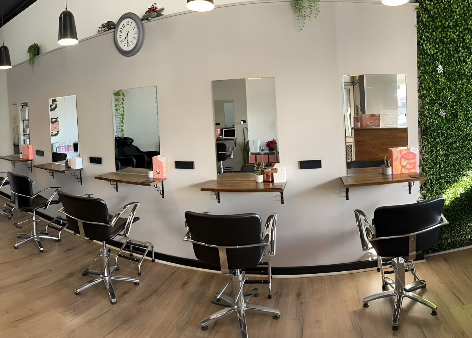 Modern salon interior at Envious Hair And Beauty, Figtree, New South Wales, AU with chic styling chairs and mirrors.