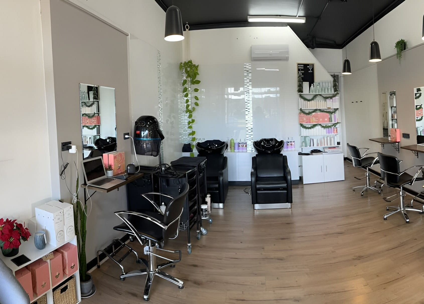 Modern salon interior at Envious Hair And Beauty, Figtree, New South Wales, AU with styling stations and decor.