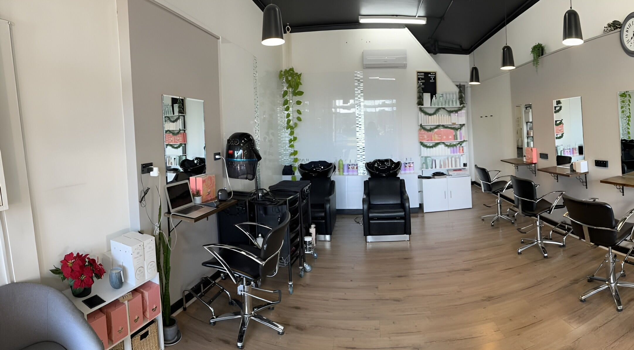 Modern salon interior at Envious Hair And Beauty, Figtree, New South Wales, AU with styling stations and decor.