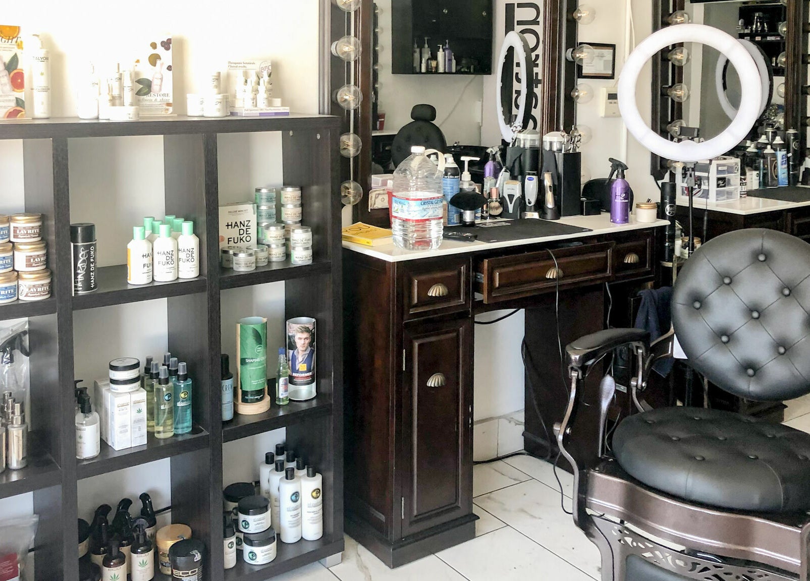 Iconic Barbershop West Hollywood's stylish interior with products and a classic chair in West Hollywood, California, US.