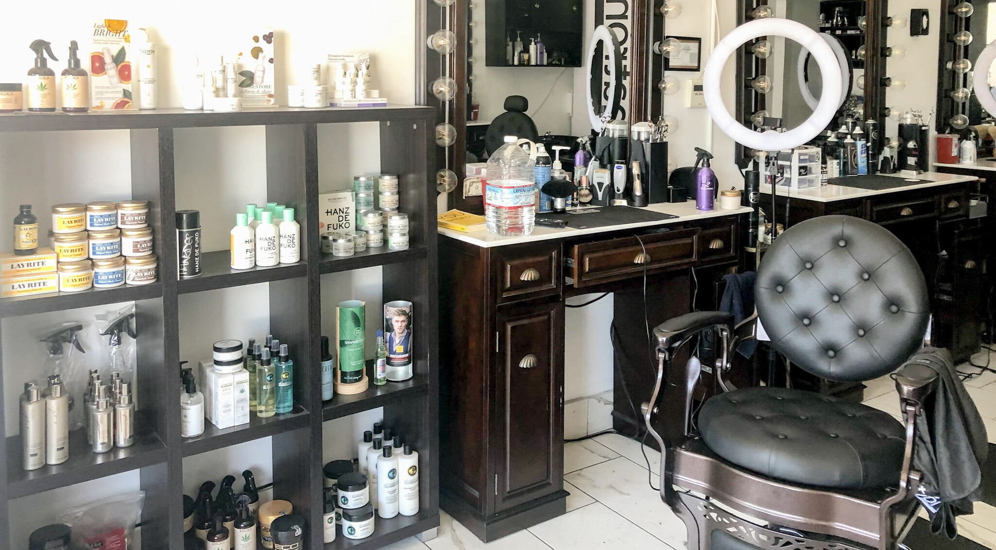 Iconic Barbershop West Hollywood's stylish interior with products and a classic chair in West Hollywood, California, US.