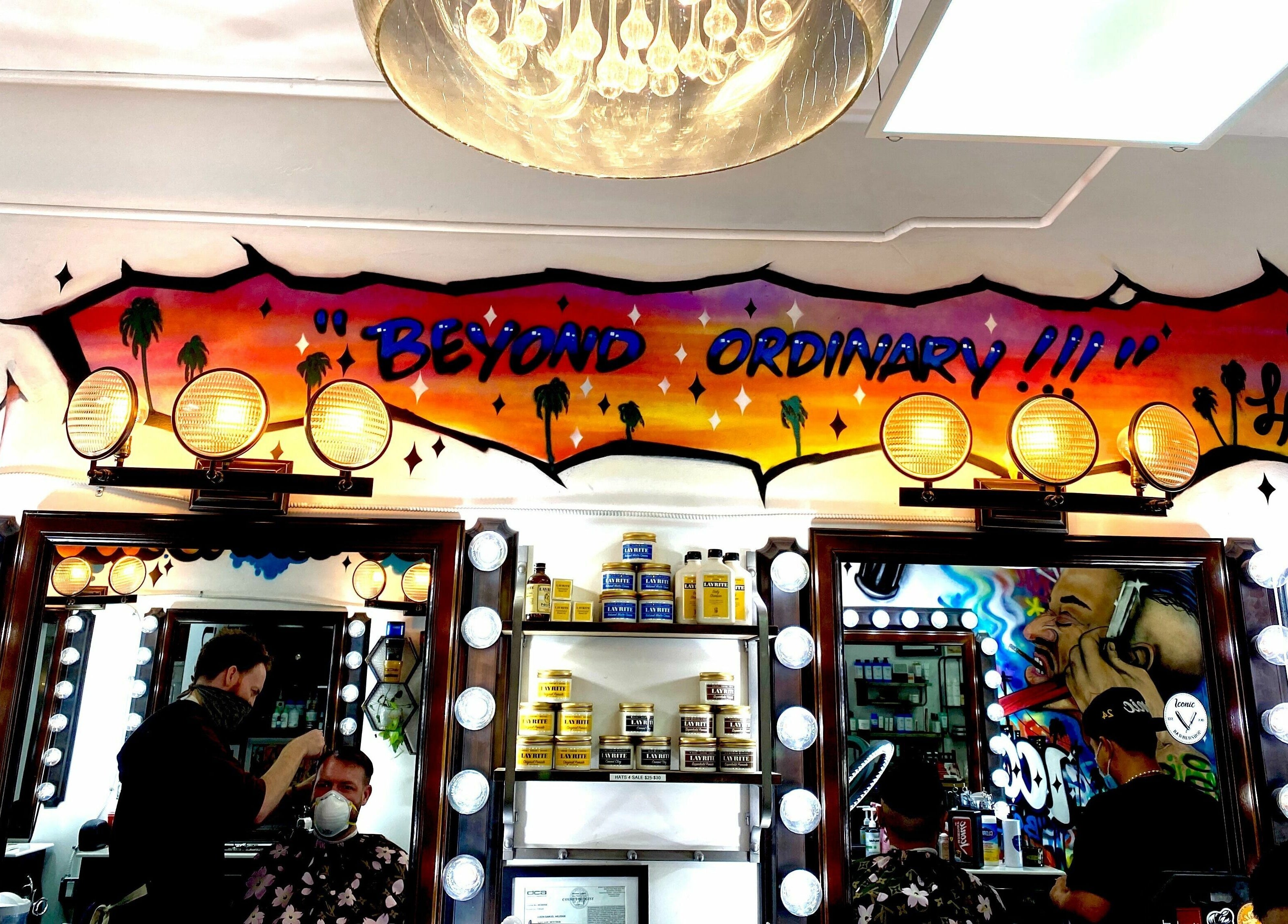 Inside Iconic Barbershop West Hollywood, featuring vibrant murals and mirrors in West Hollywood, California, US.