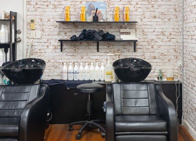 Sophisticated wash station at Claudia and Co, Toowong, Queensland, AU with chic black chairs and quality products.