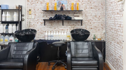 Sophisticated wash station at Claudia and Co, Toowong, Queensland, AU with chic black chairs and quality products.