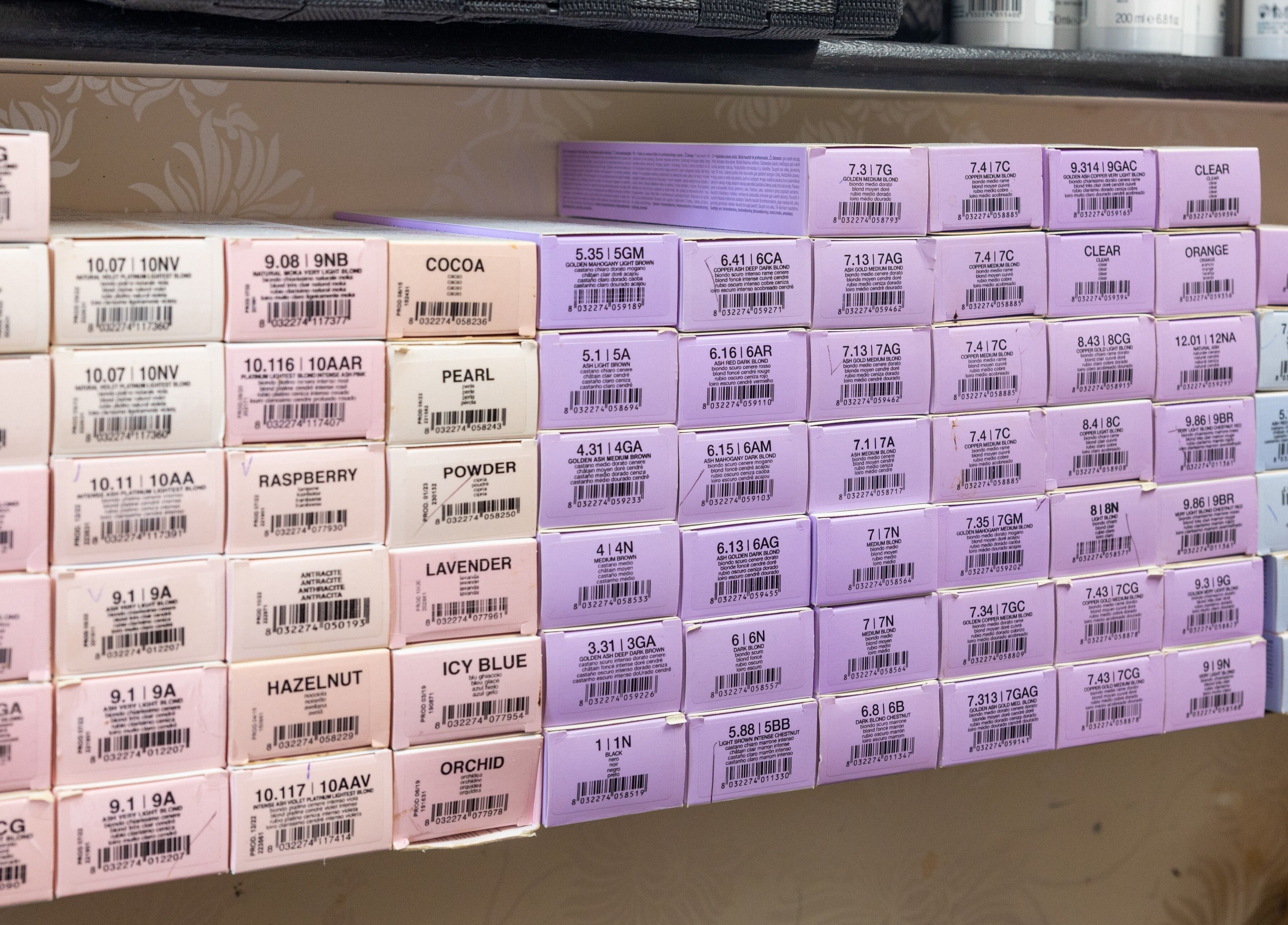 Hair color boxes neatly stacked at Claudia and Co, Toowong, Queensland, AU, offering vibrant styling options.