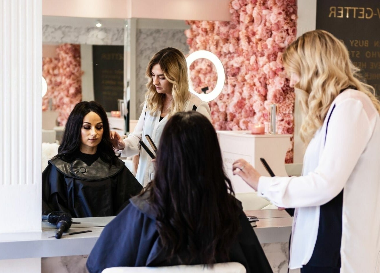 Stylists working on a client at That Rosie Glow - Edinburgh, Scotland, GB. Bright, chic salon interior.