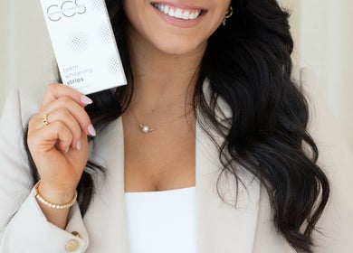 Woman holding Chrystal Clear Smile whitening product at Sans Souci, New South Wales, AU.