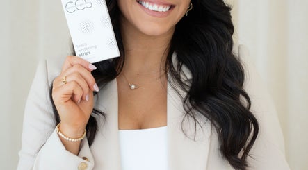 Woman holding Chrystal Clear Smile whitening product at Sans Souci, New South Wales, AU.