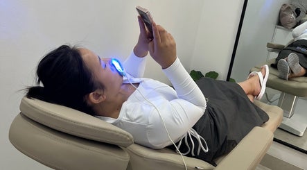 Client enjoying teeth whitening at Chrystal Clear Smile - Sans Souci, New South Wales, AU.