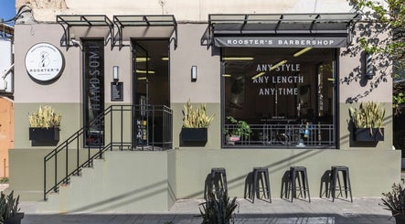Front view of Rooster's Barbershop Panormou, Αθήνα, Ελλάδα, GR with modern facade and seating.