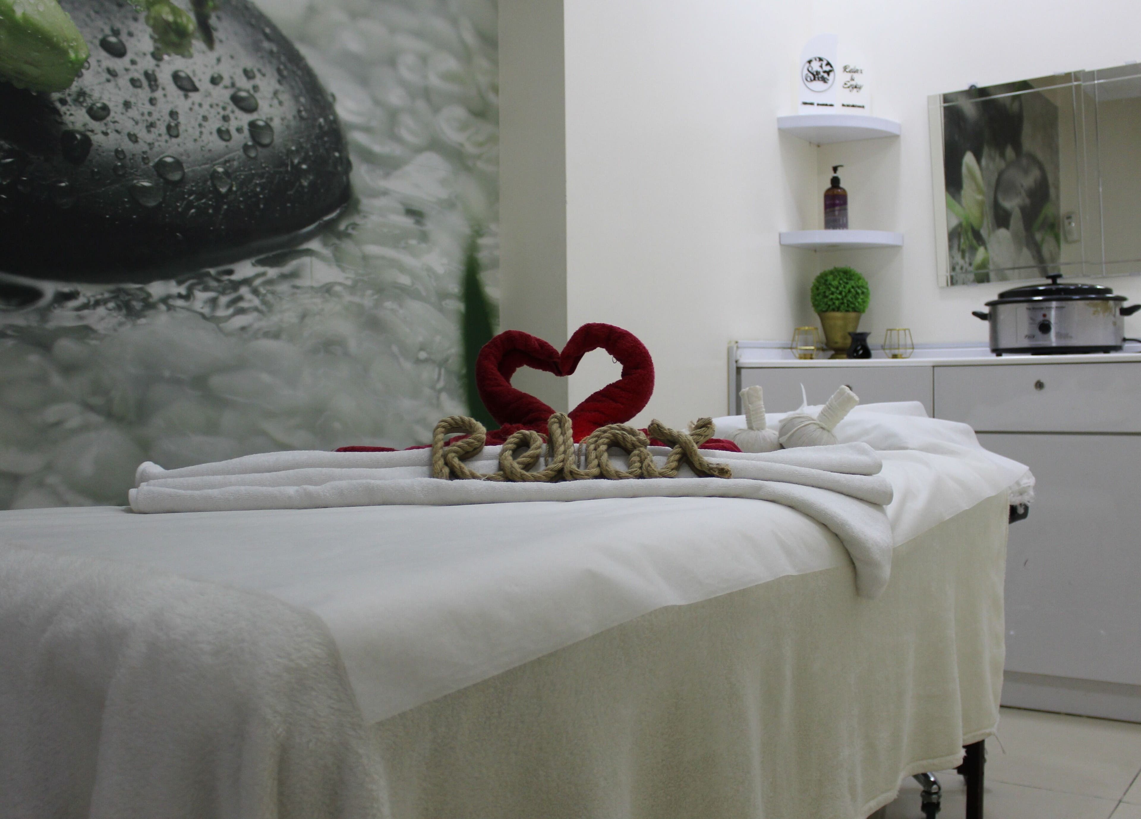 Relaxing massage room at Sois Belle Salon, Abu Dhabi, AE. Cozy spa setting with heart decor.