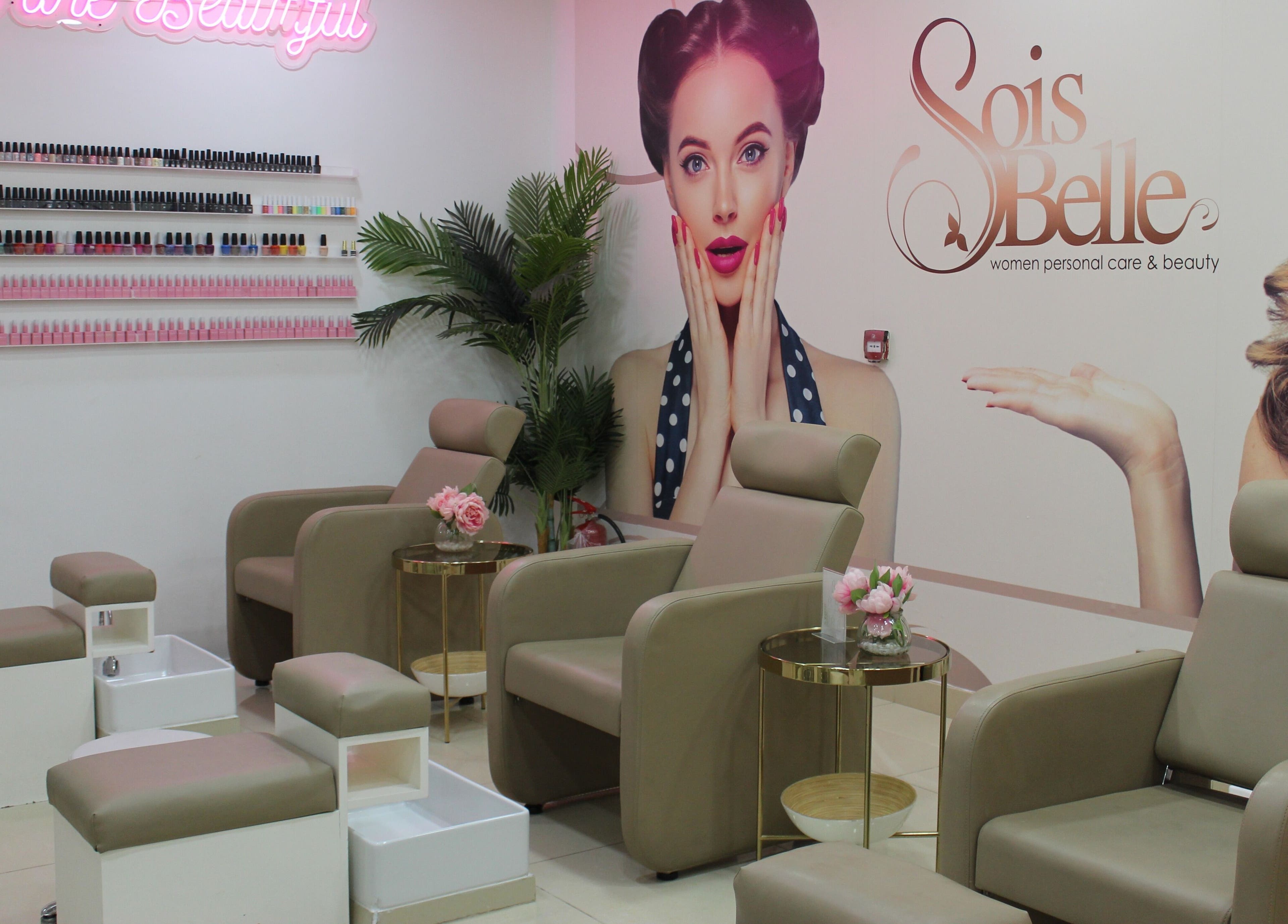 Relaxing pedicure area at Sois Belle Salon, Abu Dhabi, AE, with stylish seats and nail polish display.