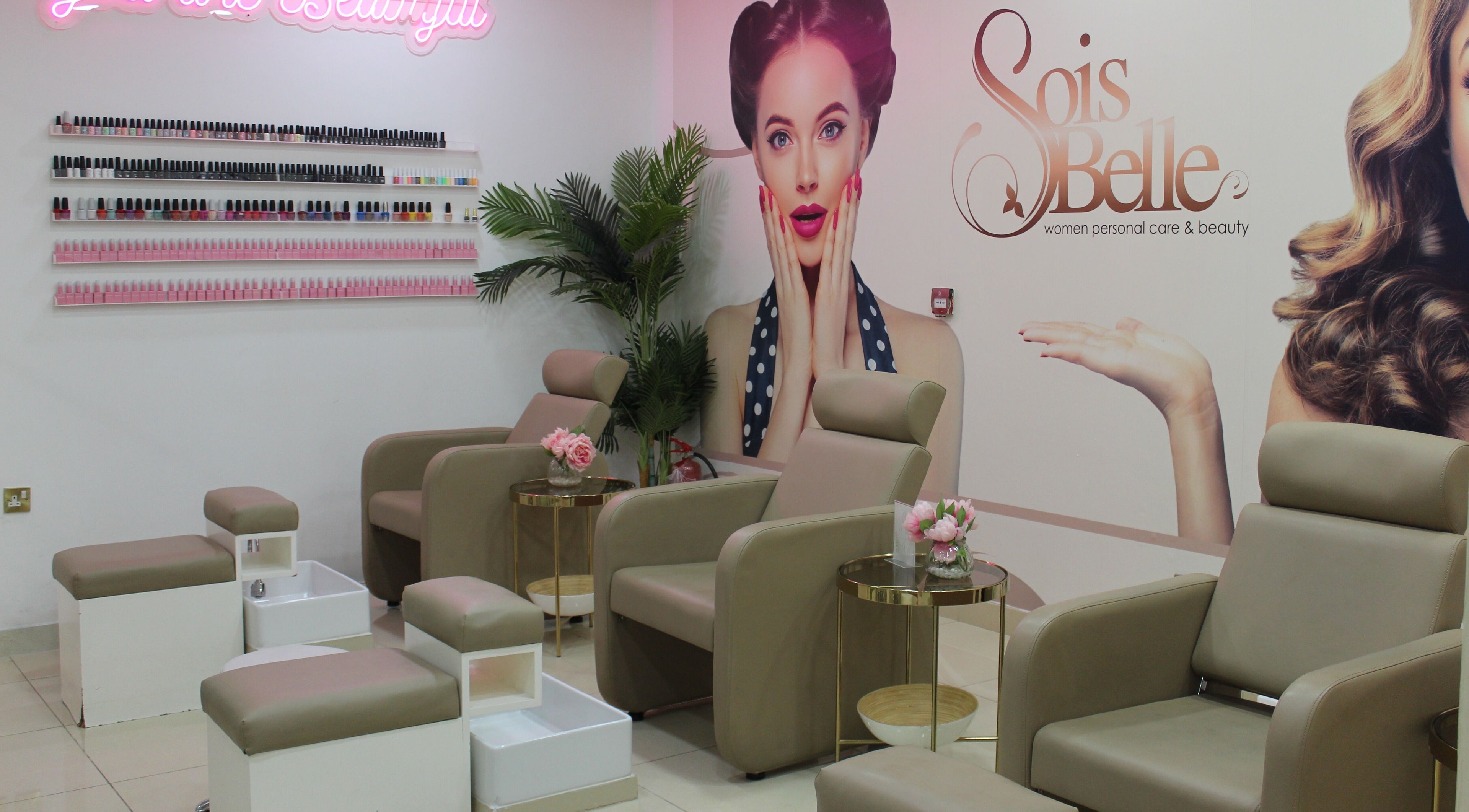 Relaxing pedicure area at Sois Belle Salon, Abu Dhabi, AE, with stylish seats and nail polish display.