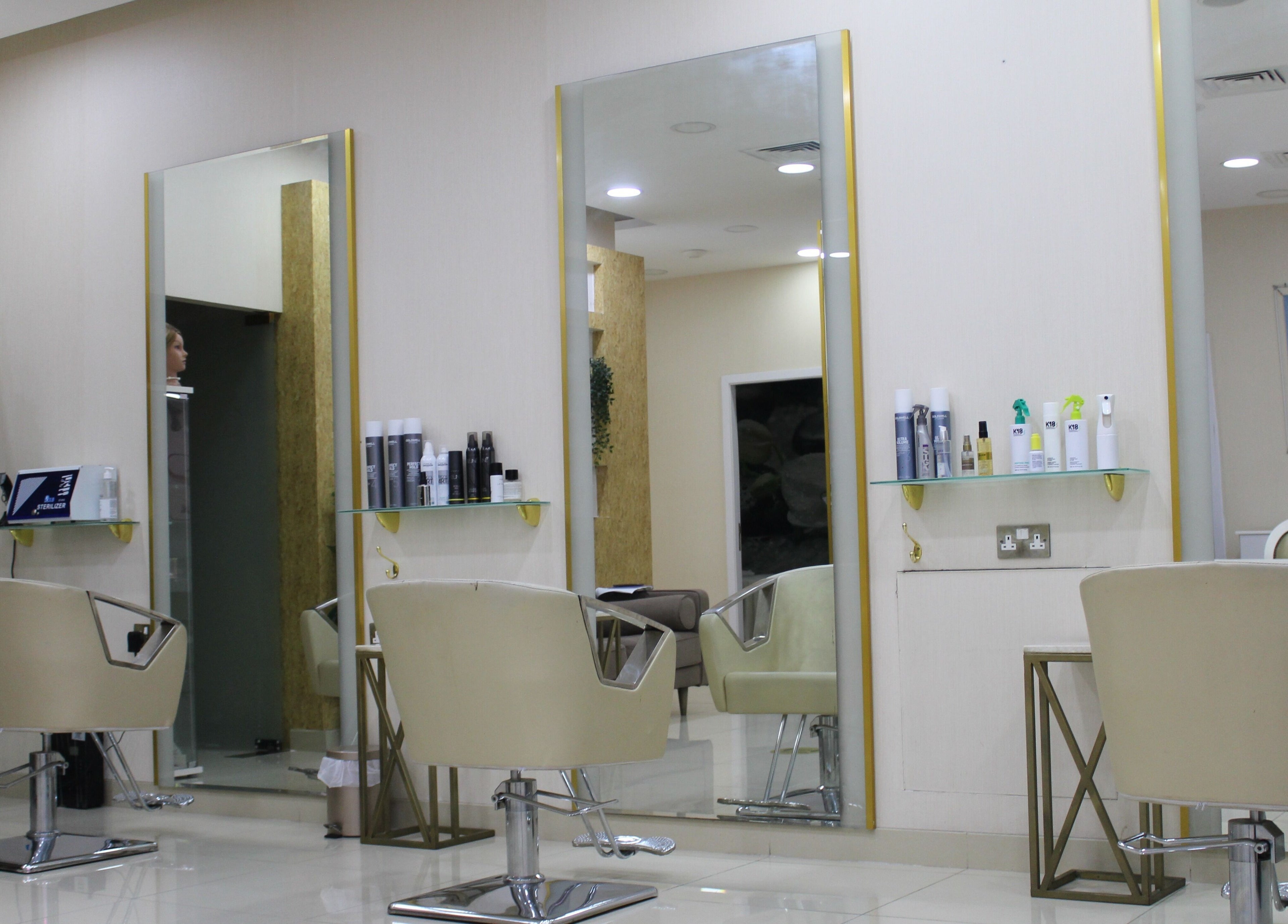 A sleek hair styling area at Sois Belle Salon in Abu Dhabi, AE featuring modern chairs and styling products.