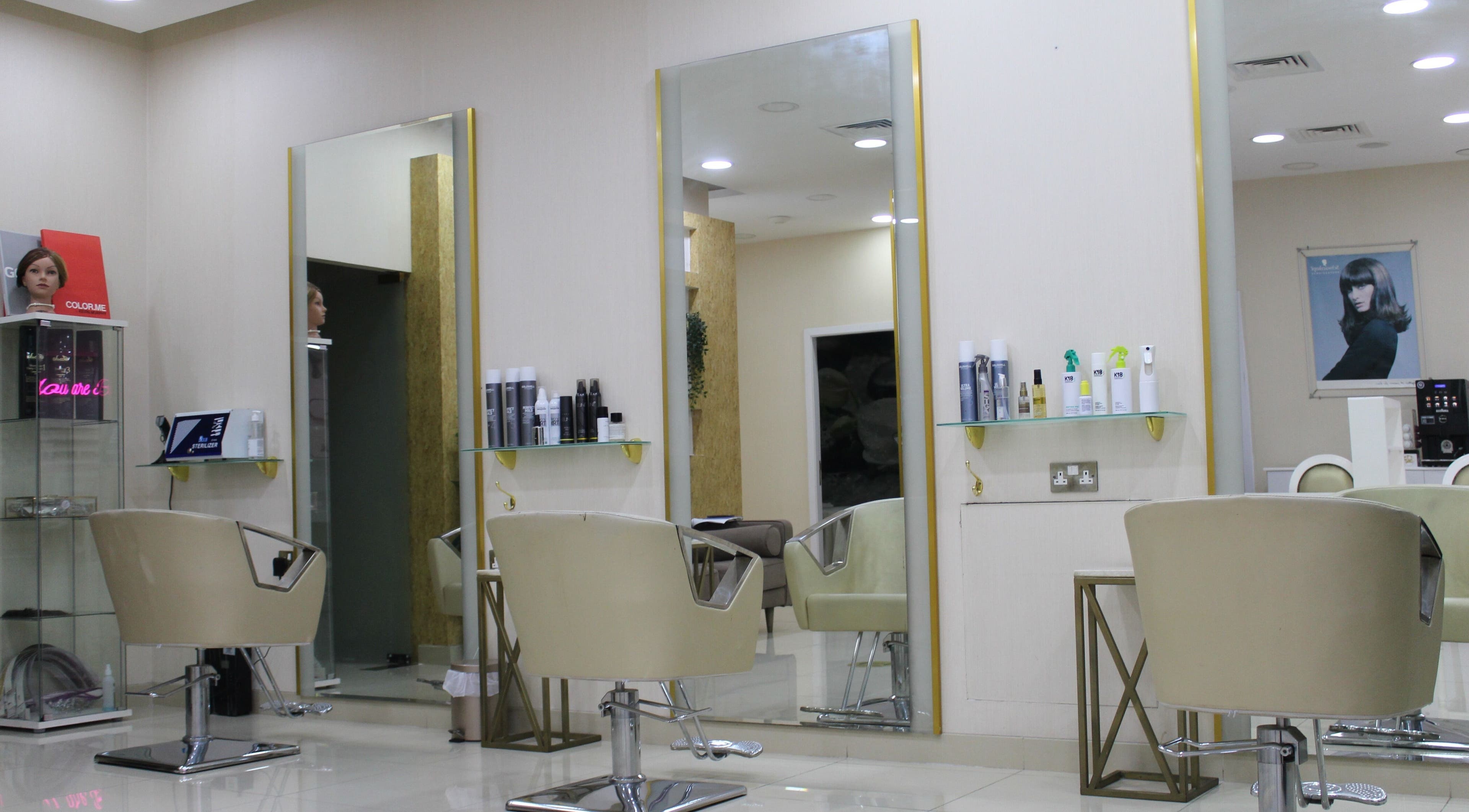 A sleek hair styling area at Sois Belle Salon in Abu Dhabi, AE featuring modern chairs and styling products.