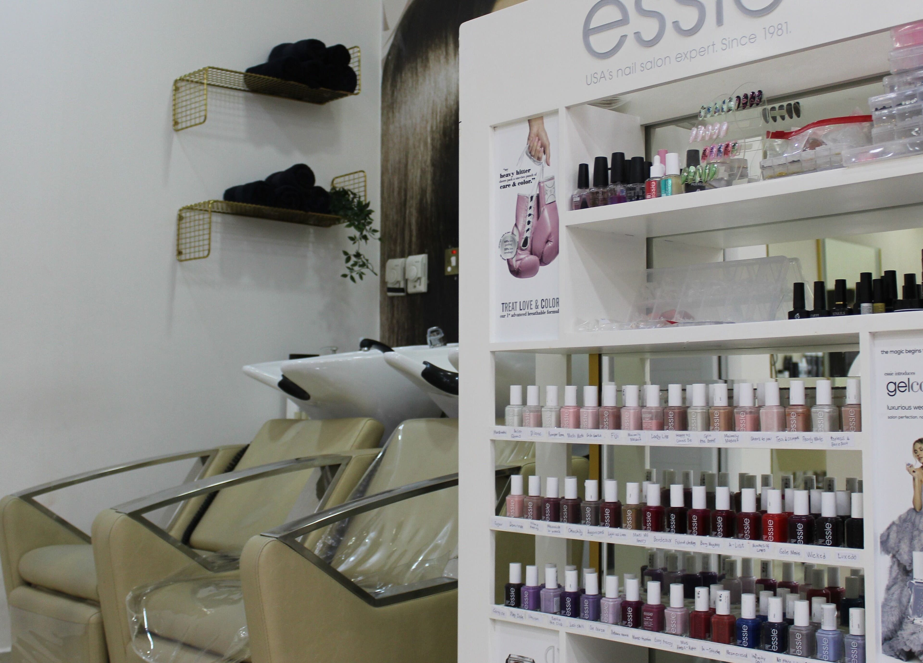 Nail polish display and salon chairs at Sois Belle Salon in Abu Dhabi, AE showcasing sleek beauty setup.