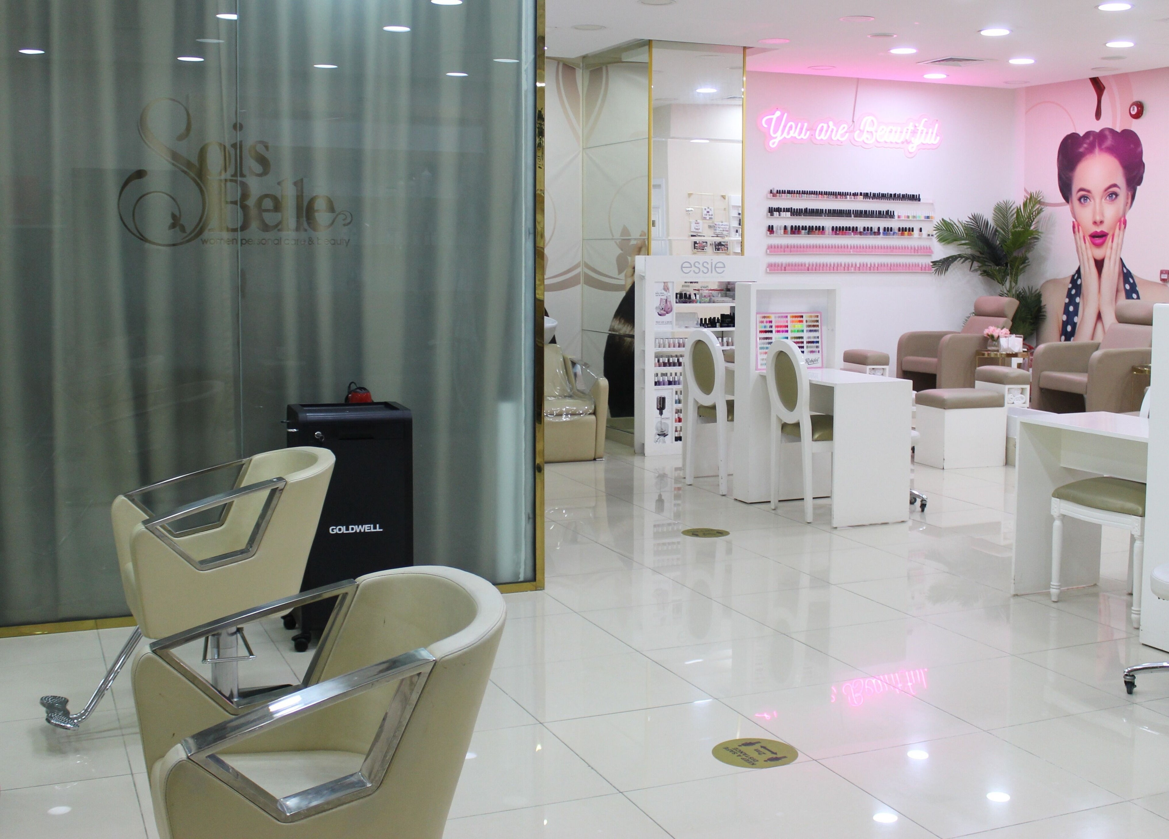 Stylish interior of Sois Belle Salon in Abu Dhabi, AE with modern chairs and beauty products.