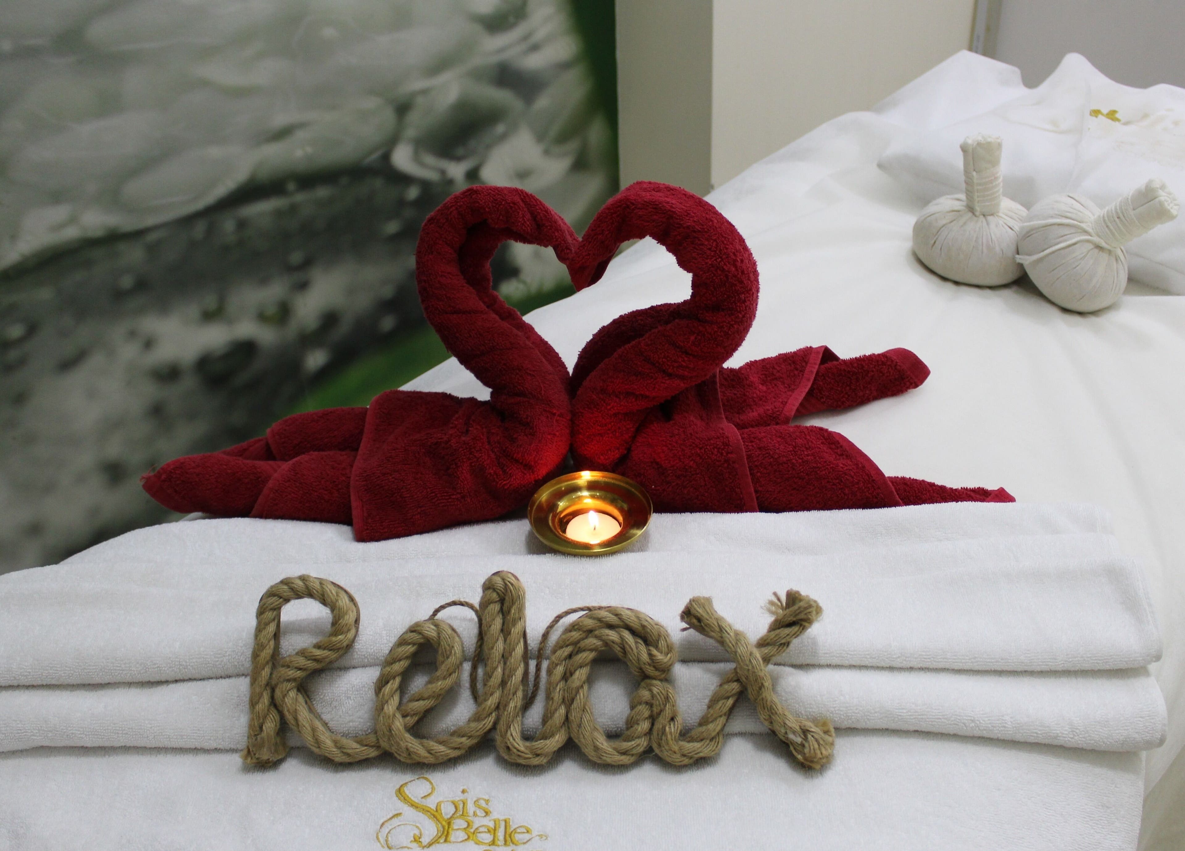Relaxing spa setup with heart-shaped towels at Sois Belle Salon, Abu Dhabi, AE.