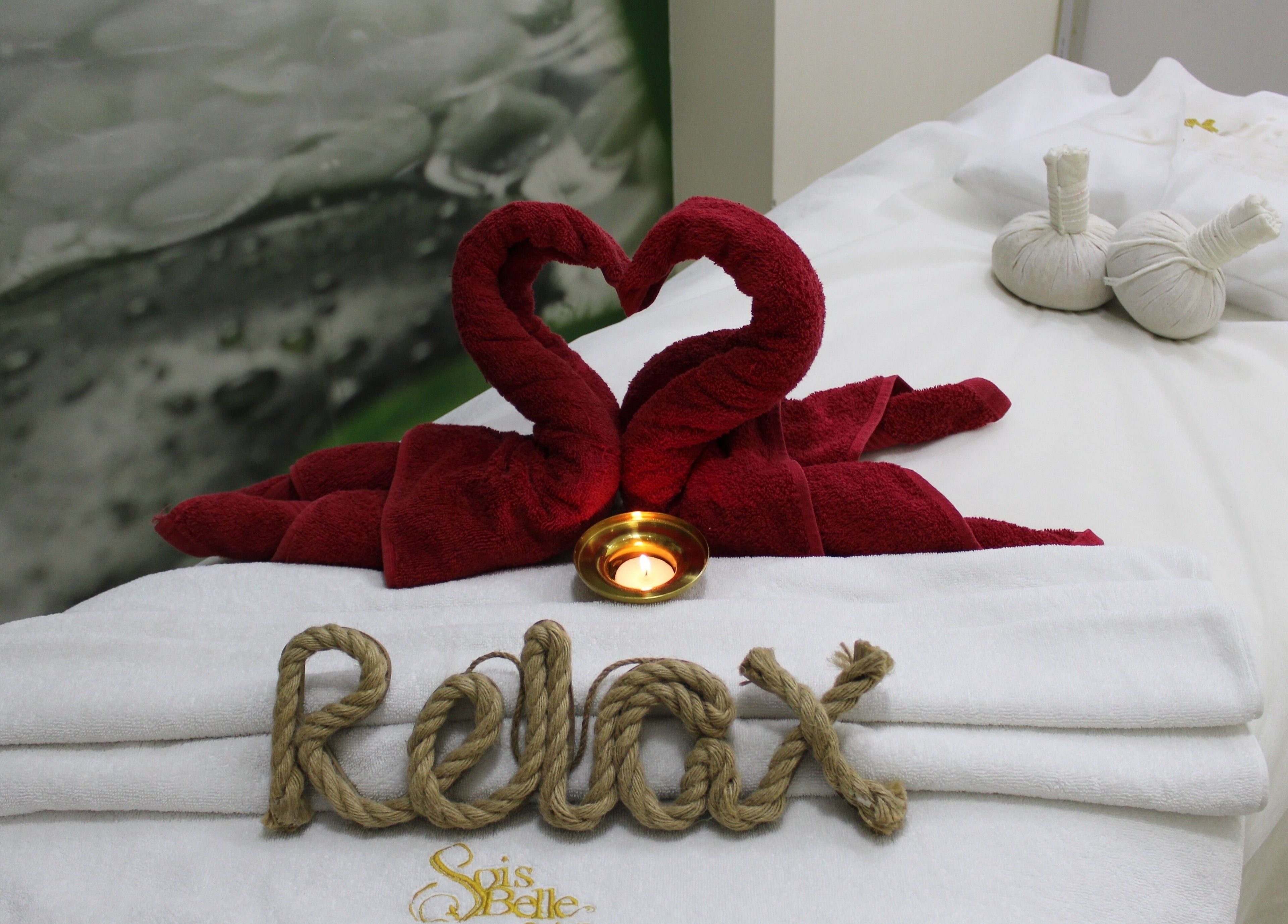 Relaxing spa setup with heart-shaped towels at Sois Belle Salon, Abu Dhabi, AE.