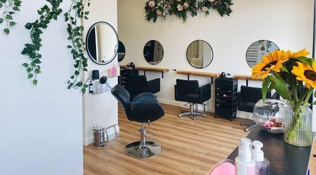 Elegant interior of The Beauty Lounge by Laura in Lossiemouth, Scotland, GB, showcasing sleek styling stations.