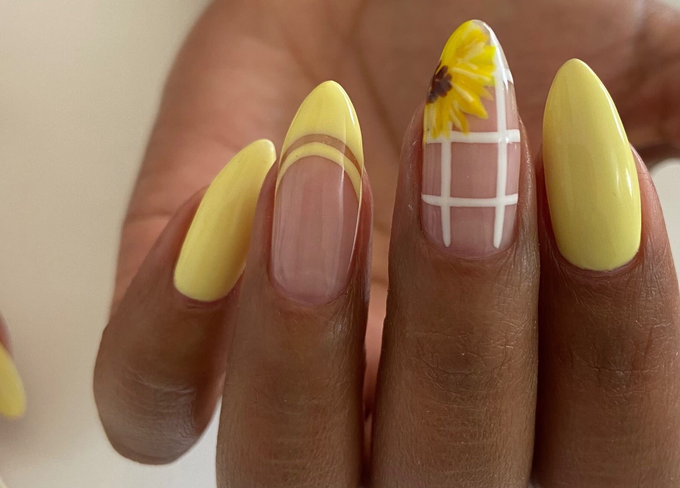 Stylish yellow nail design at Nails and Things in Johannesburg, Gauteng, ZA showcasing sunflower art.
