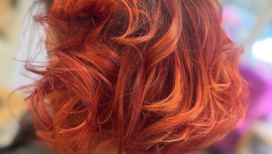 Vibrant red curls hairstyle at Angela Lewis - Architects of Hair, Gatley, England, GB.