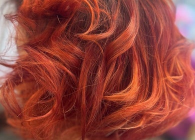 Vibrant red curls hairstyle at Angela Lewis - Architects of Hair, Gatley, England, GB.