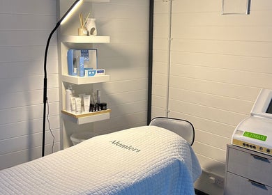 Omg Beauty treatment room in Alva, Scotland, GB, with relaxing decor and skincare products on display.