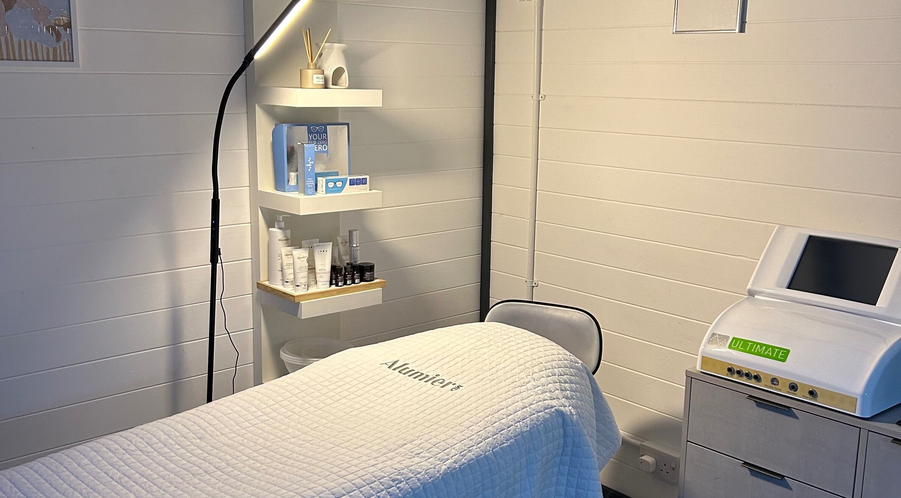 Omg Beauty treatment room in Alva, Scotland, GB, with relaxing decor and skincare products on display.