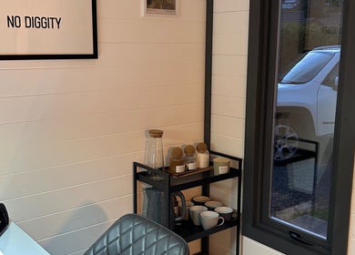 A relaxing corner at Omg Beauty, Alva, Scotland, GB featuring stylish decor and refreshments.