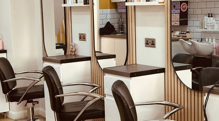 Modern salon chairs and mirrors at Clip'so March, March, England, GB, showcasing elegant interior design.