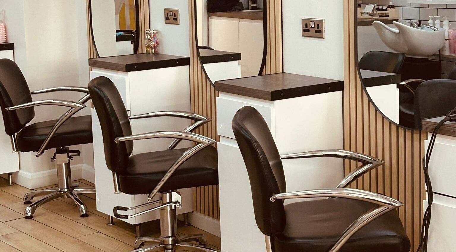Chic salon chairs at Clip'so March in March, England, GB. Modern beauty space with sleek design.