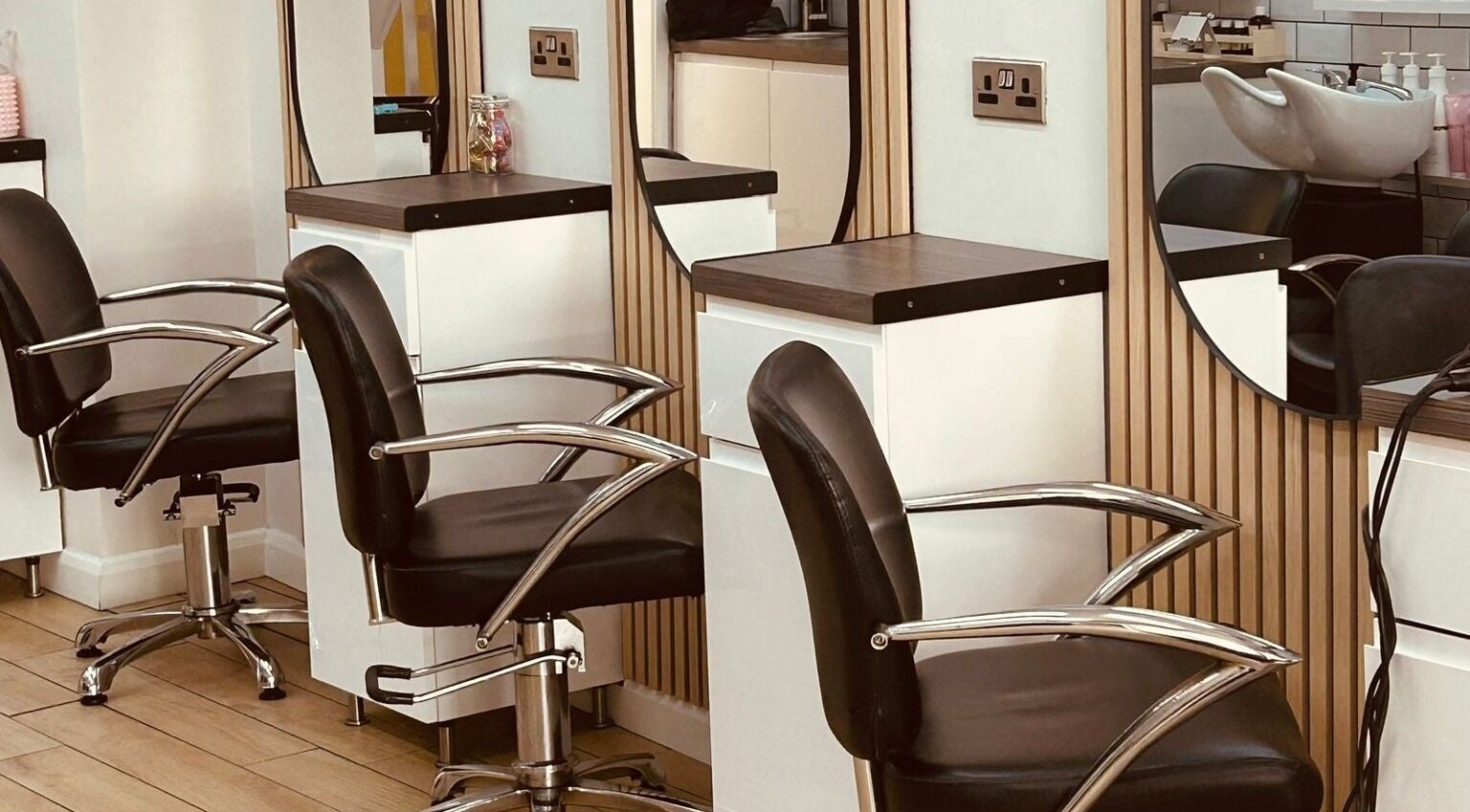 Chic salon chairs at Clip'so March in March, England, GB. Modern beauty space with sleek design.