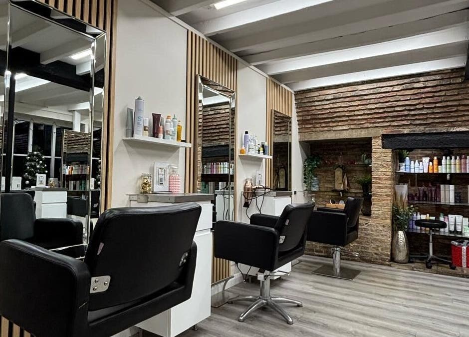 Modern interior of Clip’so Ely salon in Ely, England, GB featuring stylish chairs and shelves of beauty products.