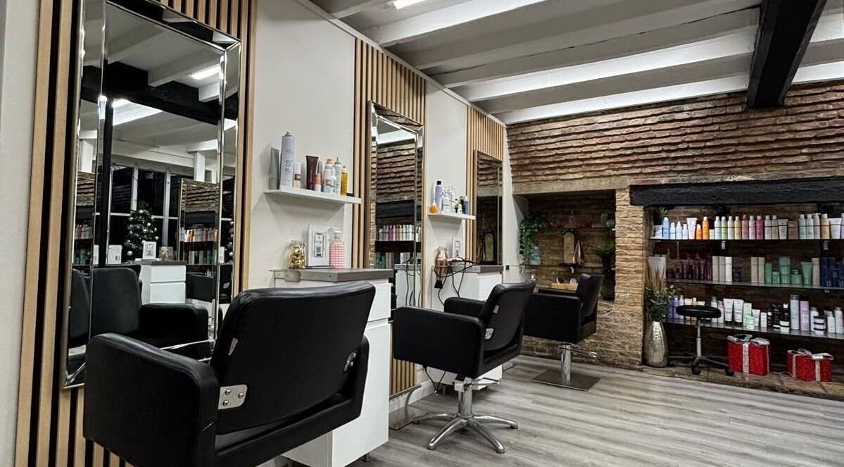 Modern interior of Clip’so Ely salon in Ely, England, GB featuring stylish chairs and shelves of beauty products.