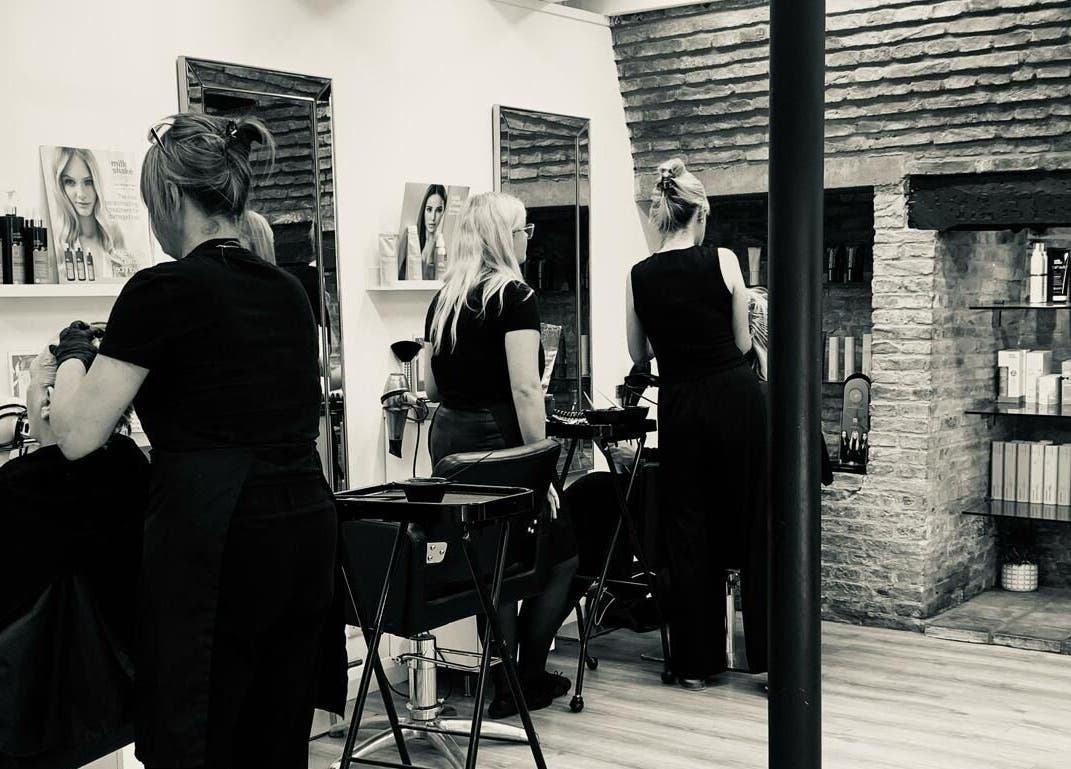 Clip’so Ely salon in Ely, England, GB with stylists working on clients' hair in a stylish setting.