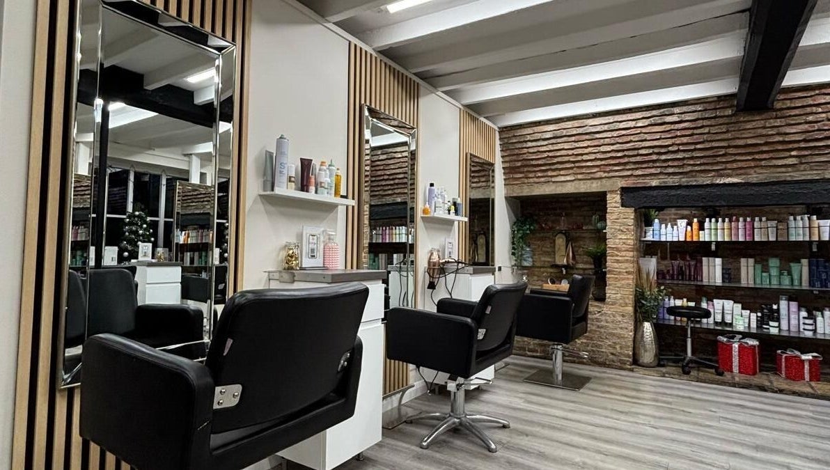 Stylish interior of Clip’so Ely in Ely, England, GB with salon chairs and beauty products.