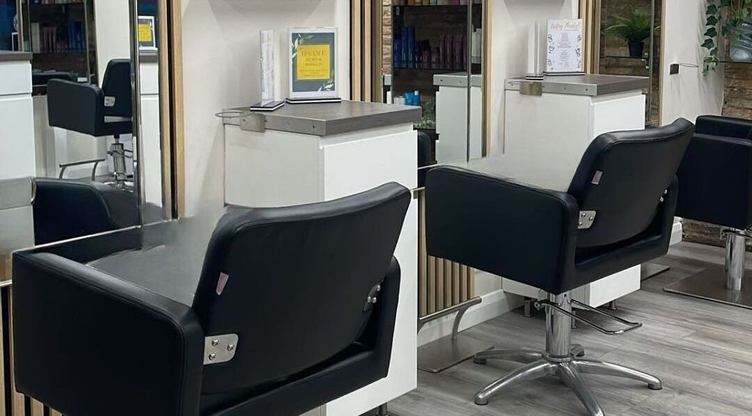 Sleek salon stations at Clip’so Ely in Ely, England, GB, showcasing modern black styling chairs and mirrors.