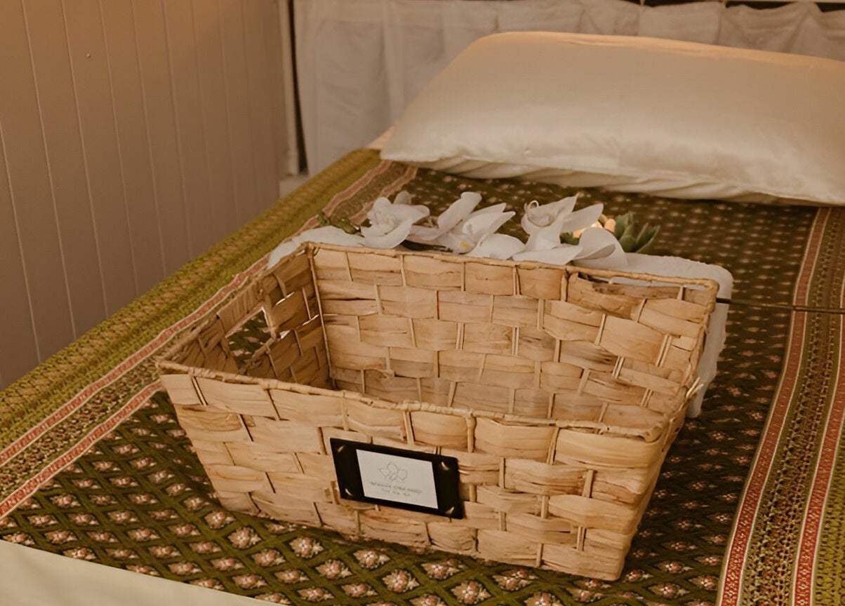Cozy massage bed at White Orchid Thai Day Spa (Toowong) with wicker basket and orchids, Toowong, Queensland, AU.
