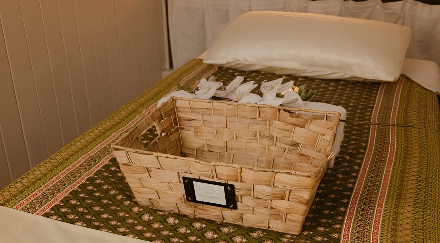 Cozy massage bed at White Orchid Thai Day Spa (Toowong) with wicker basket and orchids, Toowong, Queensland, AU.