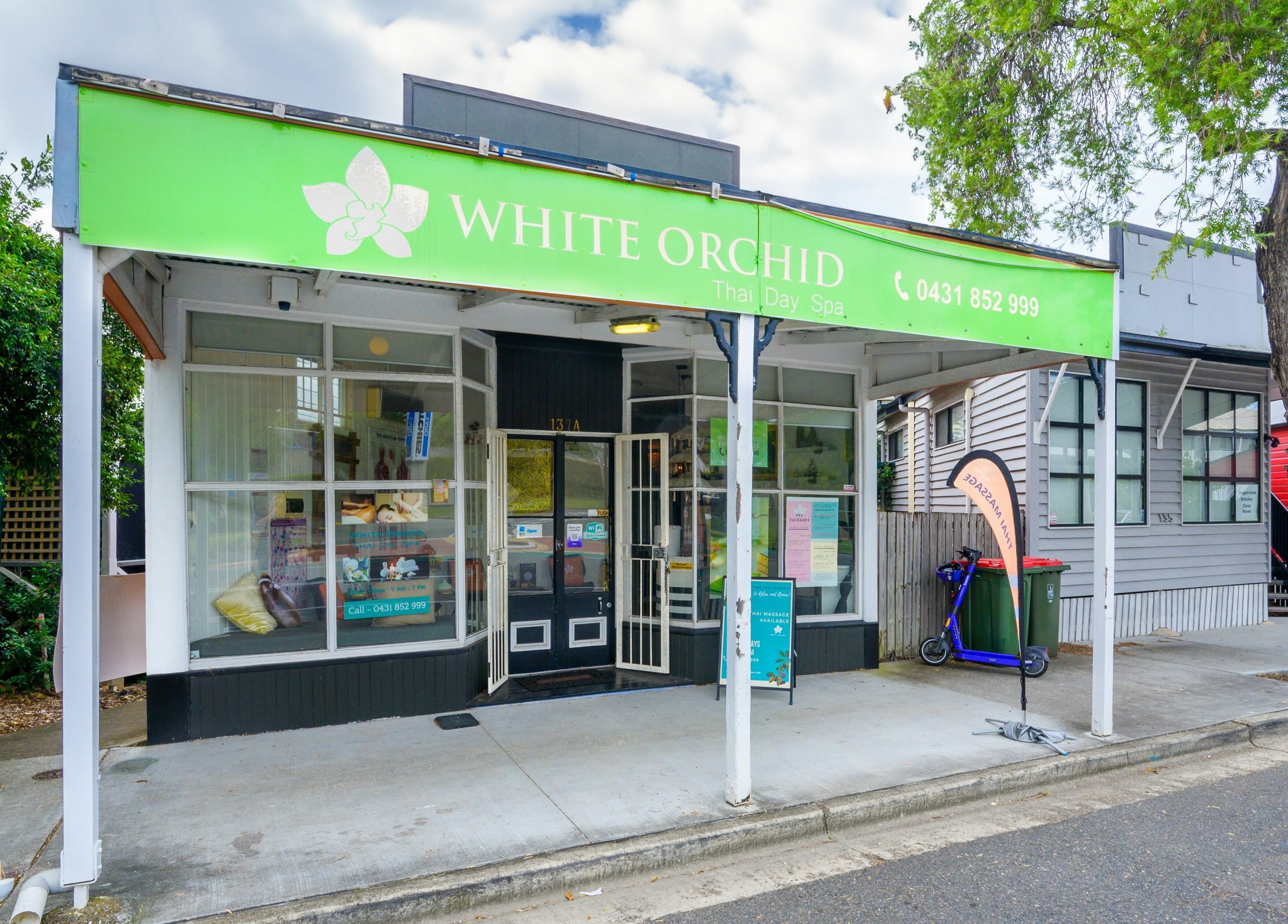 Front view of White Orchid Thai Day Spa in Toowong, Queensland, AU features inviting entrance and green signage.