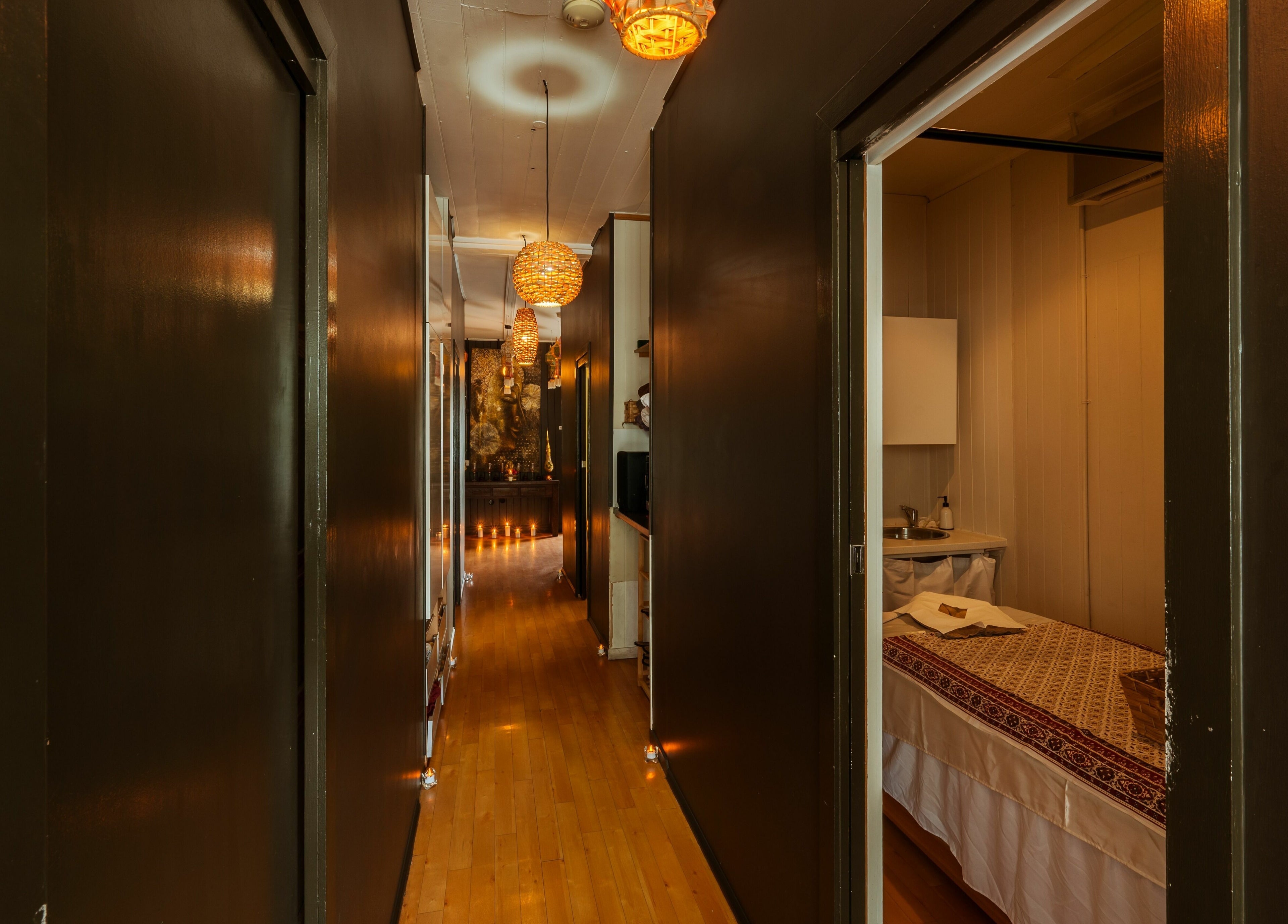 Warmly lit corridor and massage room at White Orchid Thai Day Spa, Toowong, Queensland, AU.