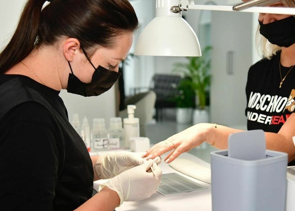 Nail technician providing expert manicure at Phenomenal Ladies Salon, Abu Dhabi, AE.