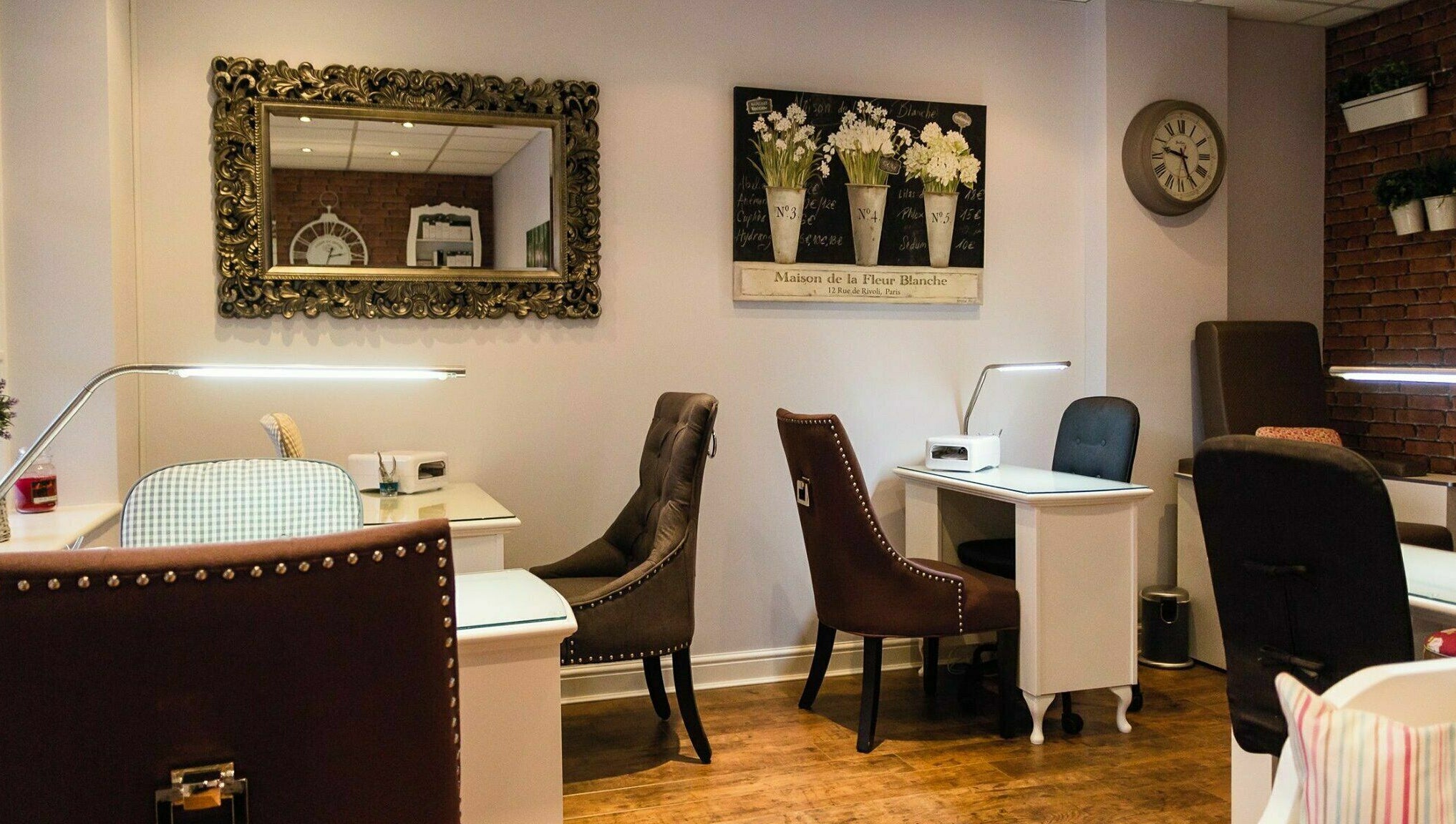 Chic nail studio in Belle La Vie, Binfield, England, GB showcasing plush chairs and ornate mirrors.