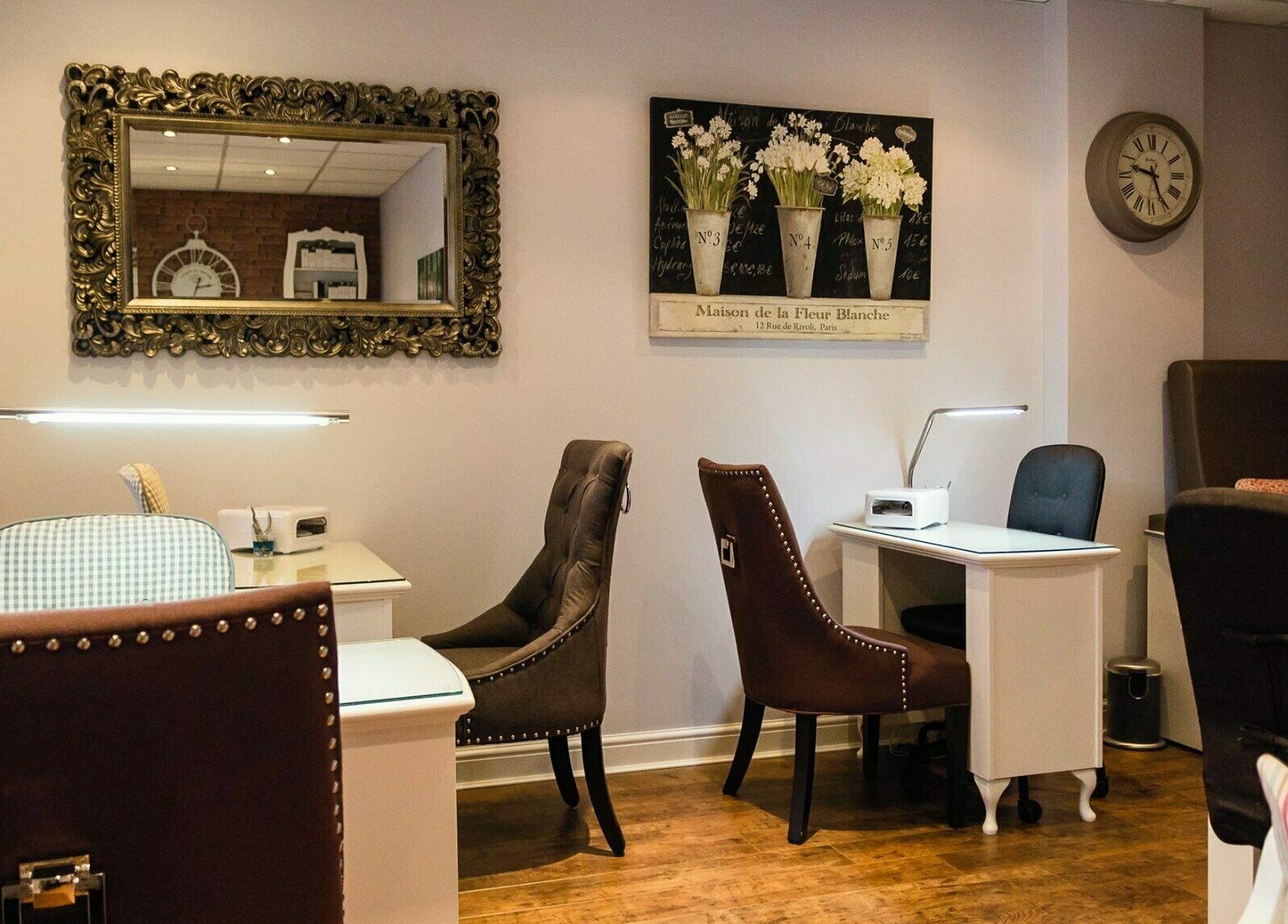 Chic nail studio in Belle La Vie, Binfield, England, GB showcasing plush chairs and ornate mirrors.